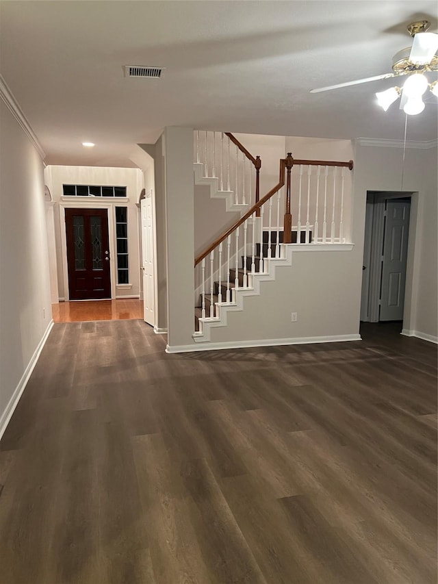 entryway with dark hardwood / wood-style floors, ceiling fan, and crown molding