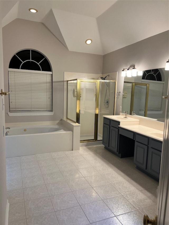 bathroom with tile patterned flooring, vanity, independent shower and bath, and vaulted ceiling