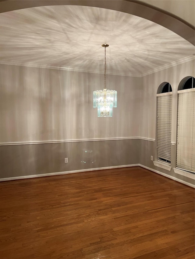 unfurnished dining area with dark wood-type flooring and a chandelier