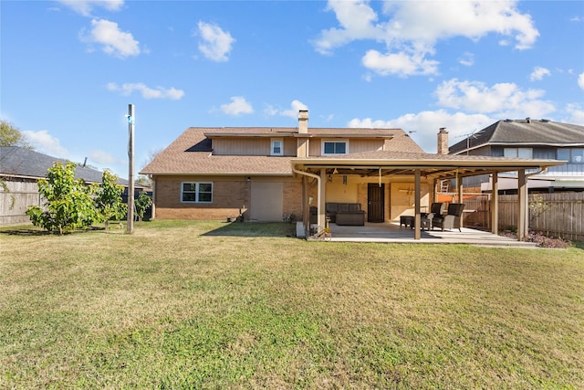 back of house with ceiling fan, a patio area, and a lawn