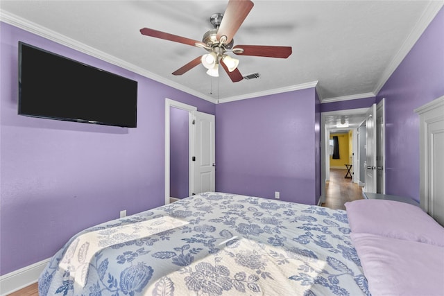 bedroom featuring ceiling fan, wood-type flooring, and ornamental molding