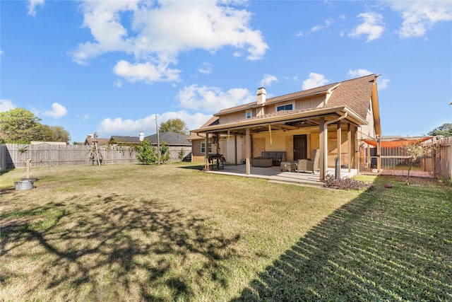 back of property featuring a yard, an outdoor hangout area, and a patio area