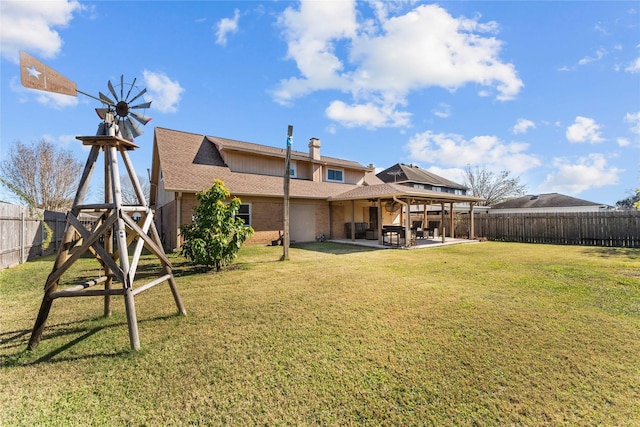 back of property featuring a yard and a patio