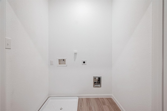 clothes washing area with hookup for a washing machine, hookup for an electric dryer, hookup for a gas dryer, and light hardwood / wood-style floors