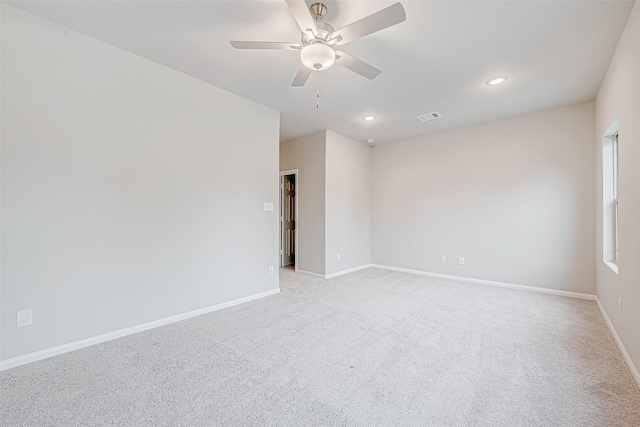 unfurnished room featuring light carpet and ceiling fan