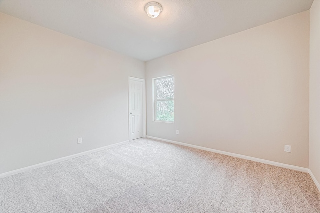 unfurnished room with light colored carpet