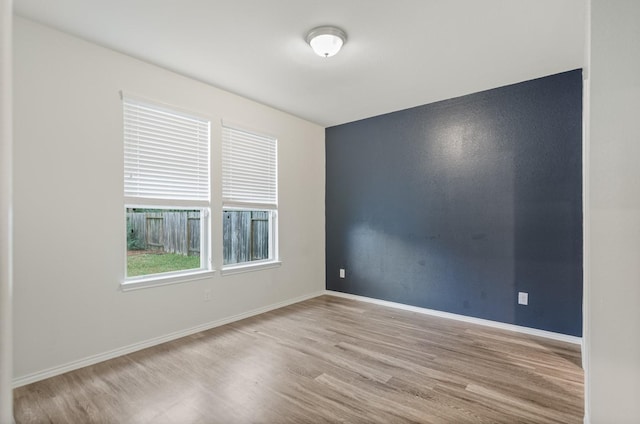 spare room featuring light wood-type flooring