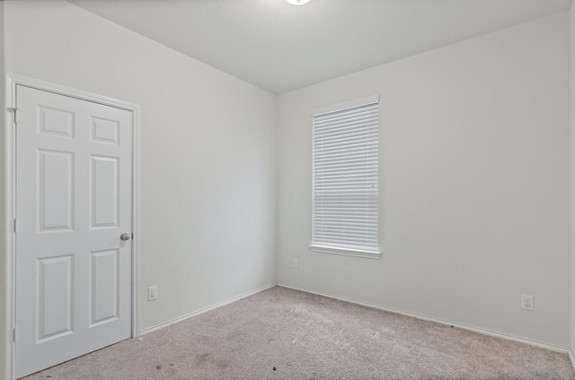 empty room featuring light carpet