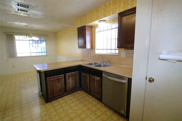 kitchen featuring dishwasher, kitchen peninsula, sink, a notable chandelier, and dark brown cabinets