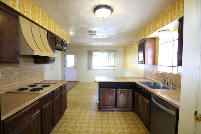 kitchen featuring dishwasher, sink, white electric cooktop, kitchen peninsula, and a chandelier