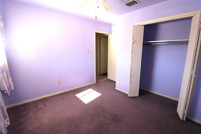 unfurnished bedroom featuring a closet, dark carpet, and ceiling fan