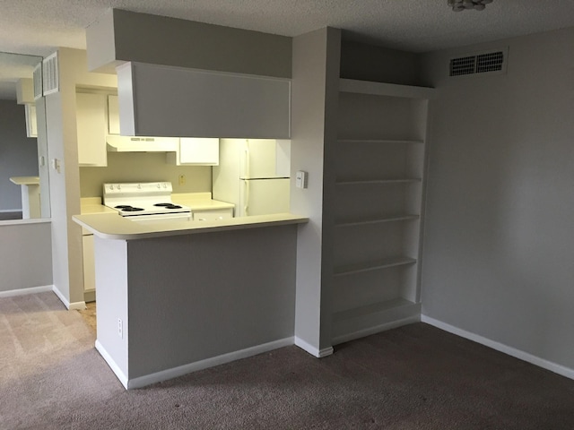 kitchen featuring kitchen peninsula, a textured ceiling, white appliances, light colored carpet, and white cabinetry