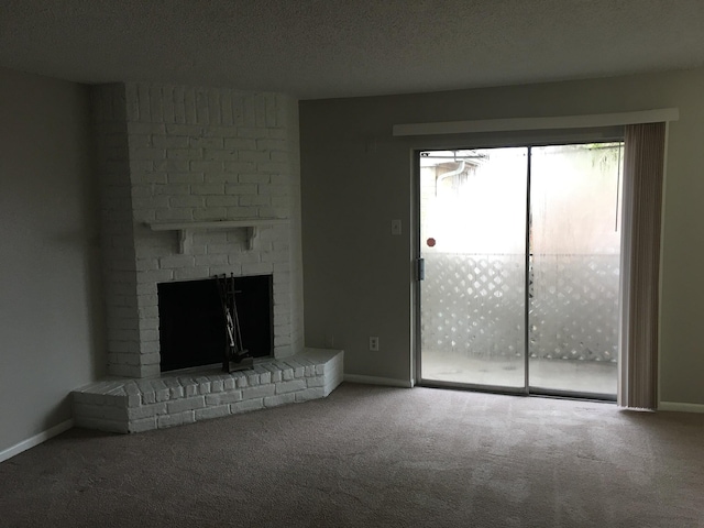 unfurnished living room featuring carpet, a fireplace, and a textured ceiling