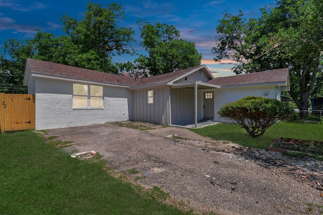 ranch-style home with a lawn