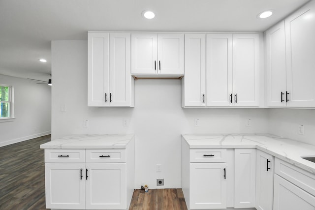 kitchen featuring light stone countertops, ceiling fan, dark hardwood / wood-style flooring, and white cabinetry