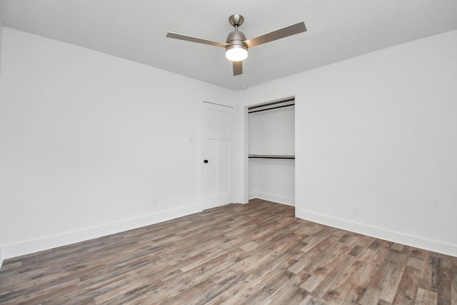 unfurnished bedroom with hardwood / wood-style floors, ceiling fan, and a closet