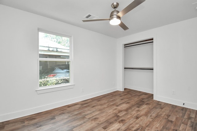 unfurnished bedroom with hardwood / wood-style floors, a closet, and ceiling fan