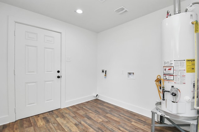 laundry area with hookup for an electric dryer, dark hardwood / wood-style floors, hookup for a washing machine, and water heater