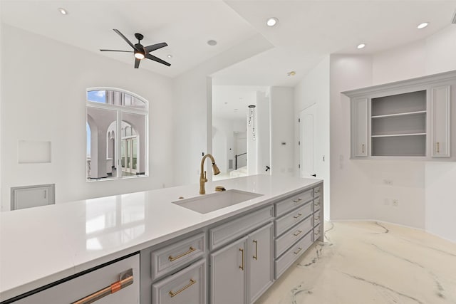 kitchen featuring light countertops, stainless steel dishwasher, a sink, and recessed lighting