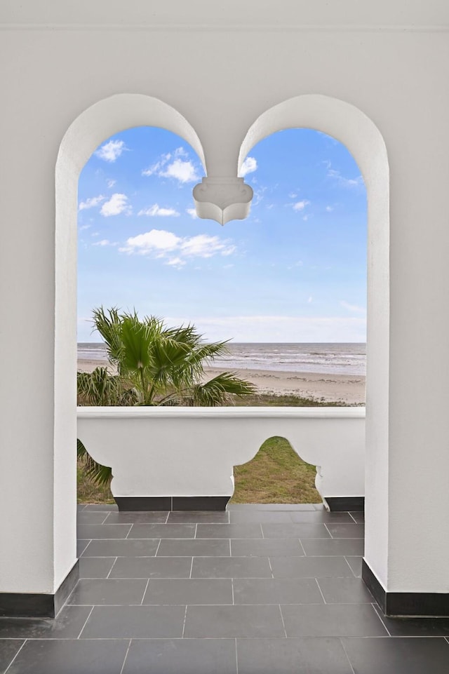 view of patio featuring a water view and a view of the beach