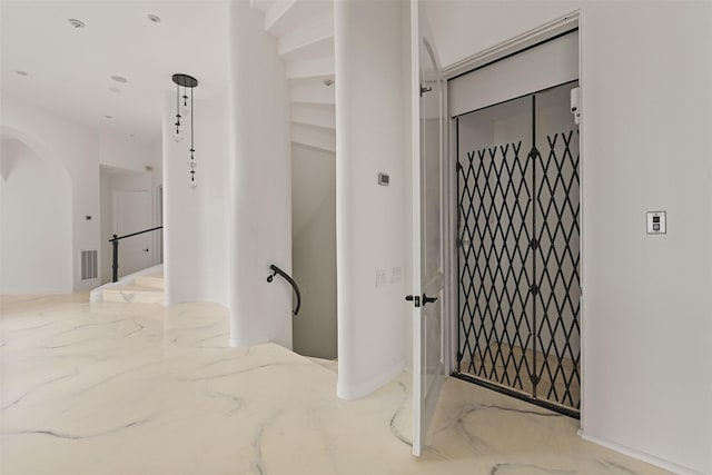 hall featuring marble finish floor and visible vents