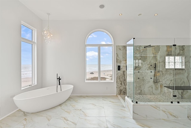 full bathroom with a view of the beach, marble finish floor, a water view, and a marble finish shower