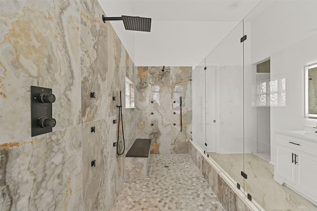 bathroom with marble finish floor, vanity, and a marble finish shower