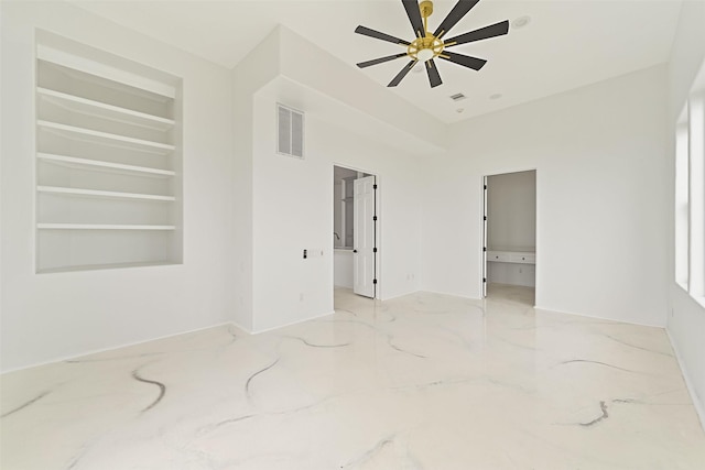 unfurnished room featuring built in shelves, marble finish floor, visible vents, and a ceiling fan