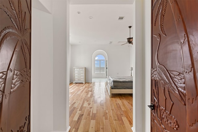 corridor featuring visible vents and light wood finished floors