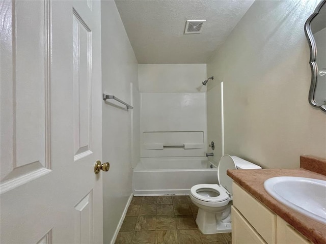 full bathroom featuring washtub / shower combination, a textured ceiling, vanity, and toilet