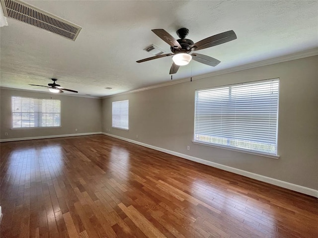 spare room with hardwood / wood-style floors, ceiling fan, and ornamental molding