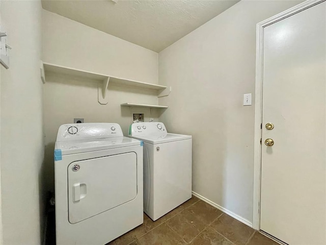 laundry room featuring tile patterned flooring and washing machine and clothes dryer