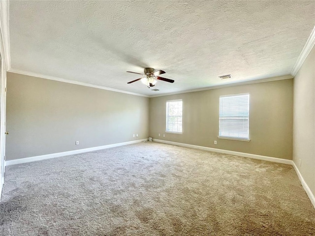 carpeted spare room featuring ceiling fan, a textured ceiling, and ornamental molding