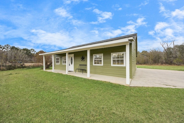 back of property featuring a yard and a patio