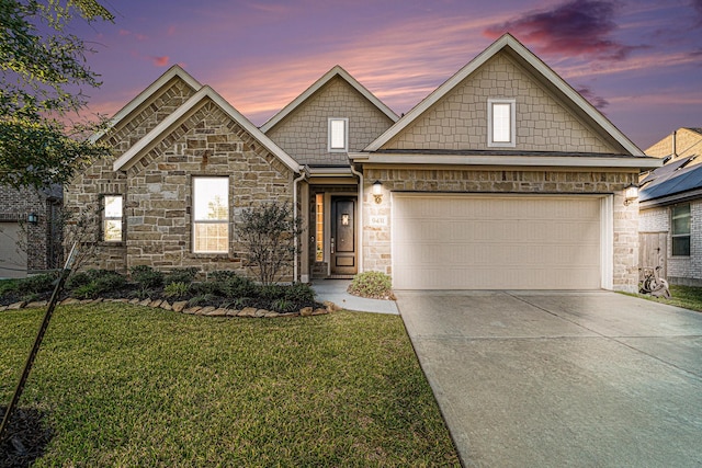 view of front of home featuring a garage and a lawn