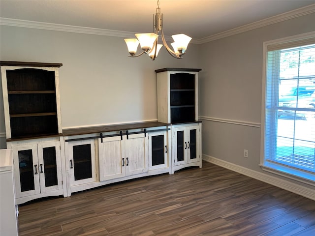 interior space with dark hardwood / wood-style floors, ornamental molding, and an inviting chandelier