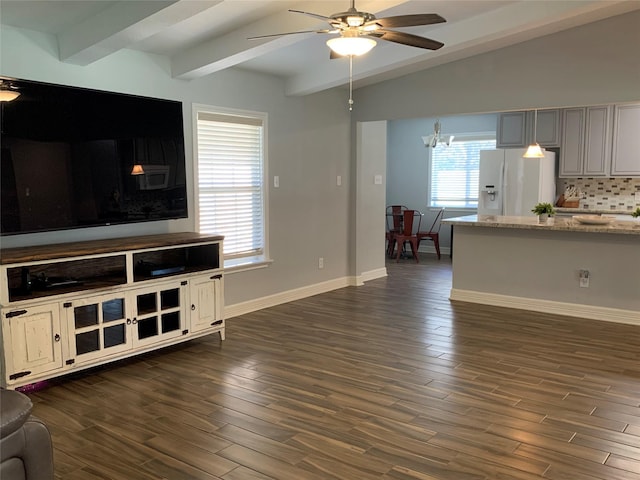 living room featuring ceiling fan with notable chandelier, dark hardwood / wood-style flooring, and lofted ceiling with beams