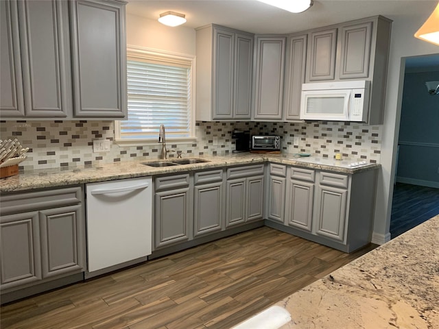 kitchen featuring decorative backsplash, dark hardwood / wood-style flooring, sink, and white appliances