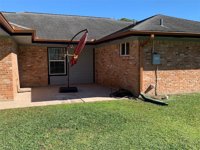 rear view of property featuring a lawn and a patio area