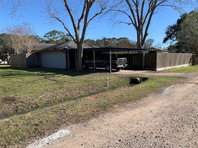 view of outbuilding featuring a carport and a lawn