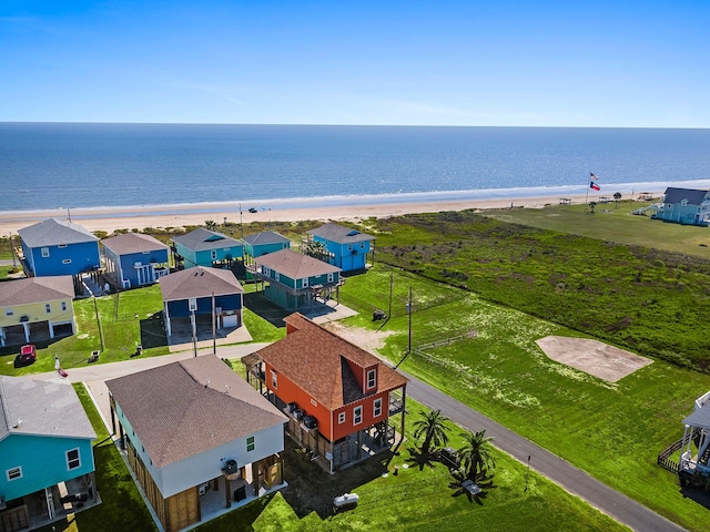 birds eye view of property with a view of the beach and a water view