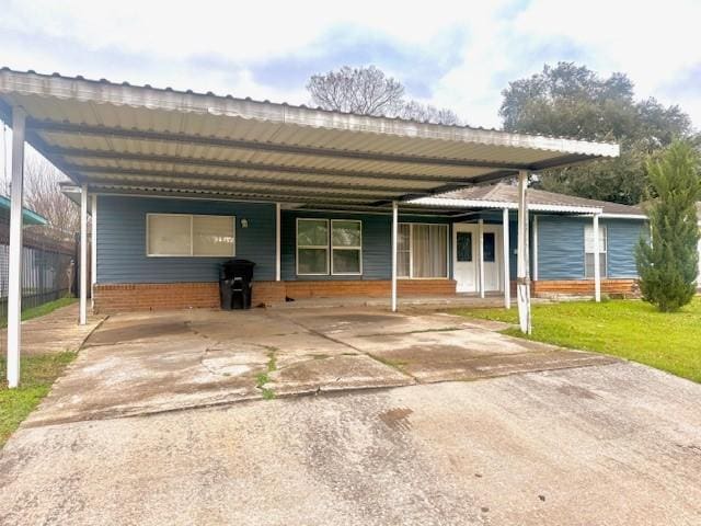 view of front of property with a front yard and a carport