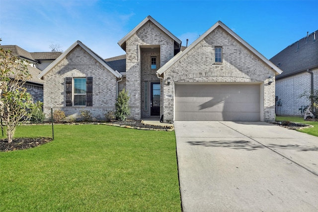 french country inspired facade featuring an attached garage, brick siding, driveway, and a front yard