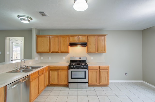 kitchen featuring sink, light tile patterned flooring, and appliances with stainless steel finishes