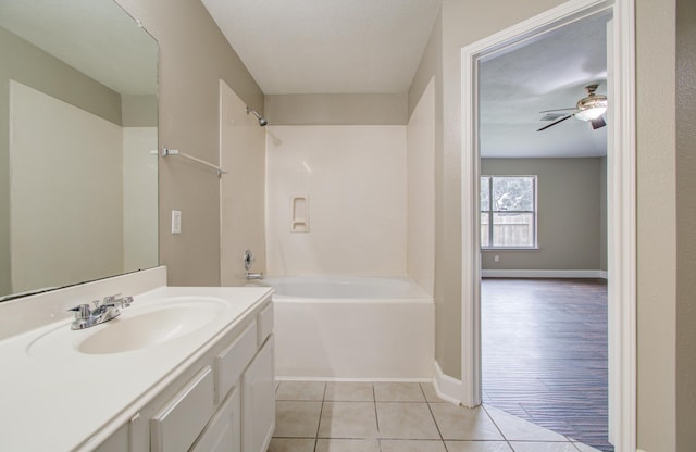 bathroom with tile patterned floors, shower / bathing tub combination, ceiling fan, and vanity