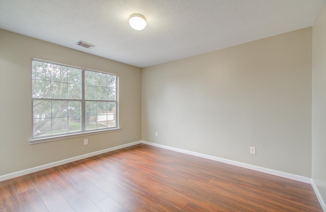 empty room featuring wood-type flooring