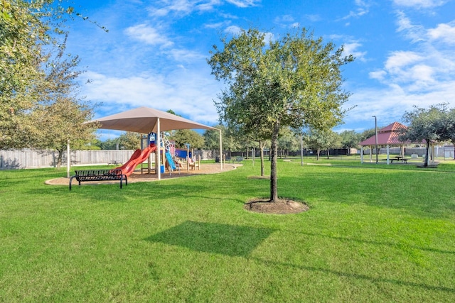 view of property's community with a lawn, a gazebo, and a playground