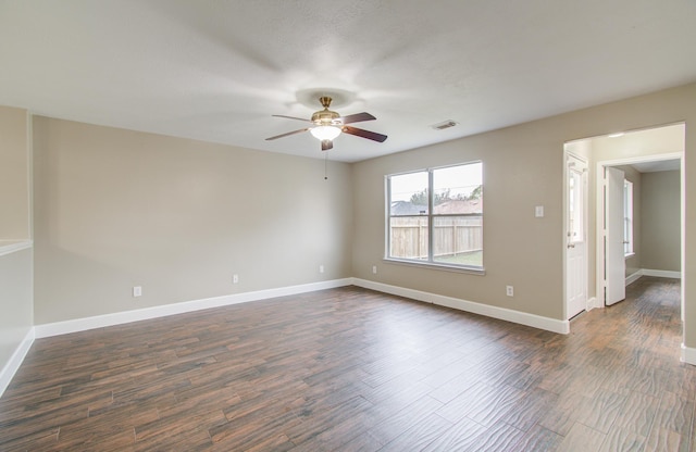 empty room featuring ceiling fan and dark wood-type flooring