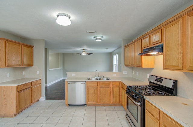 kitchen with ceiling fan, sink, kitchen peninsula, light tile patterned floors, and appliances with stainless steel finishes