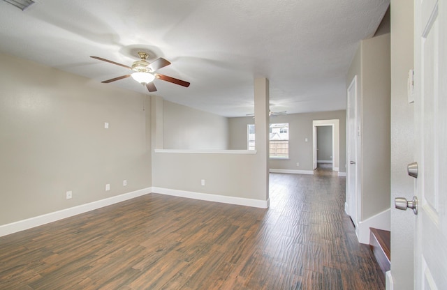 empty room featuring dark hardwood / wood-style flooring and ceiling fan